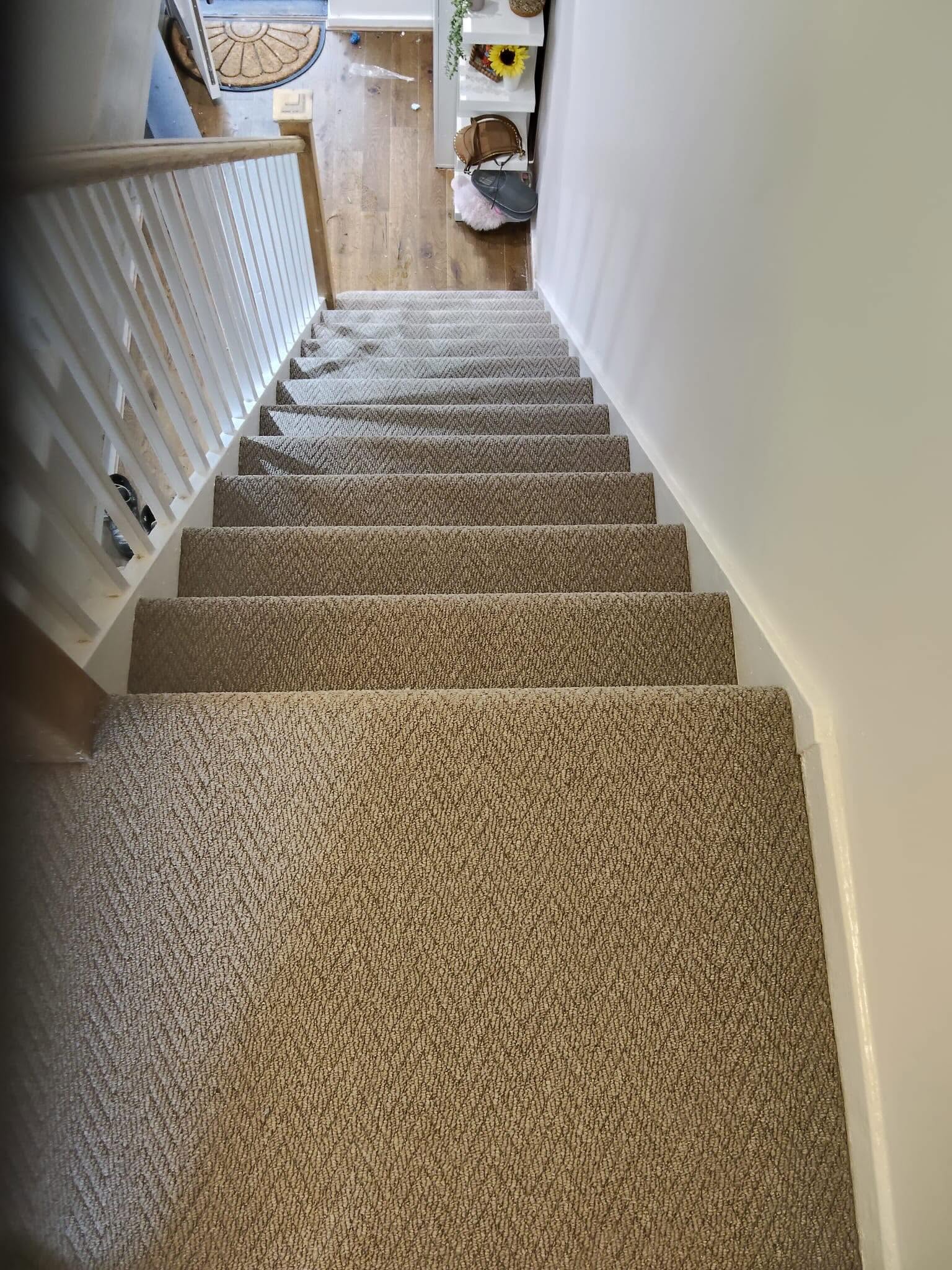 Herringbone carpet installation on a full staircase